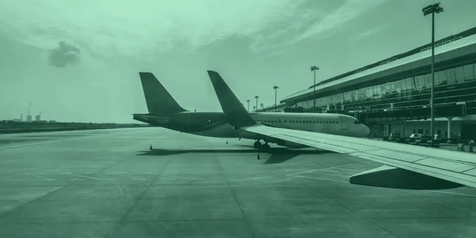 Aircraft parked beside an airport terminal